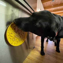 Load image into Gallery viewer, Dog licks up treats from Duckies Design Emat Enrichment Lick Mat stuck on refrigerator
