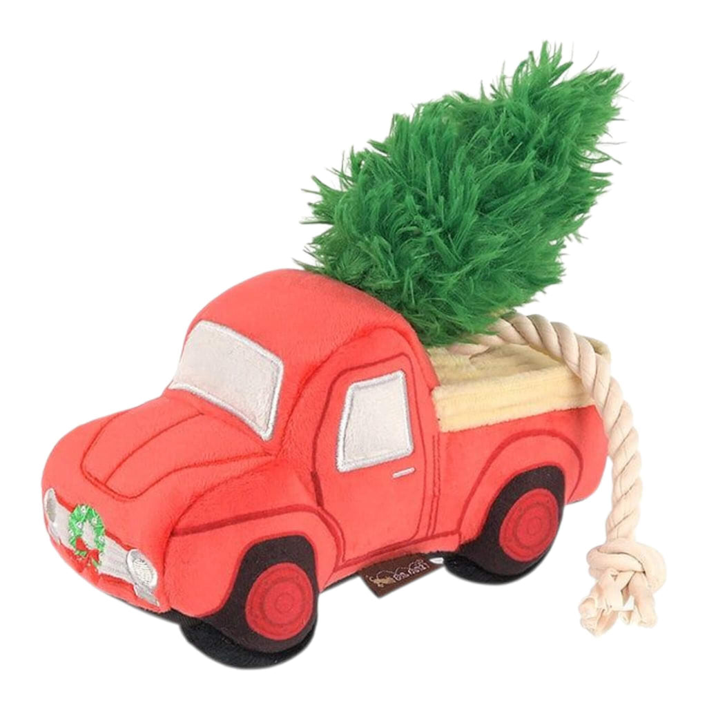 Red plush dog toy truck with a green tree on a white background