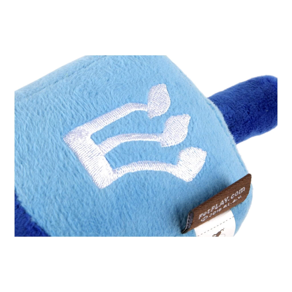 Blue and white plush dog toy with a brand tag on a white background