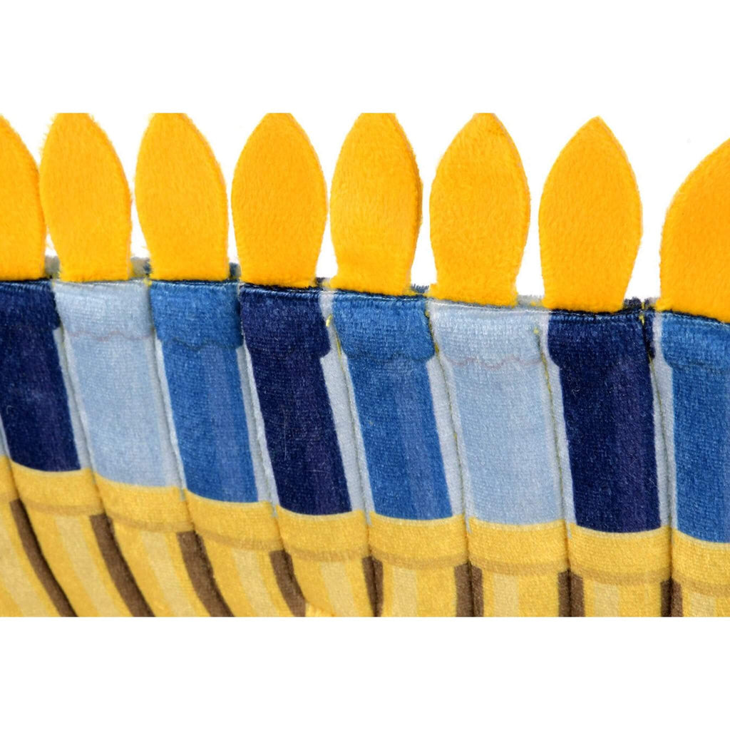 Set of colorful candles with blue and yellow holders on a white background