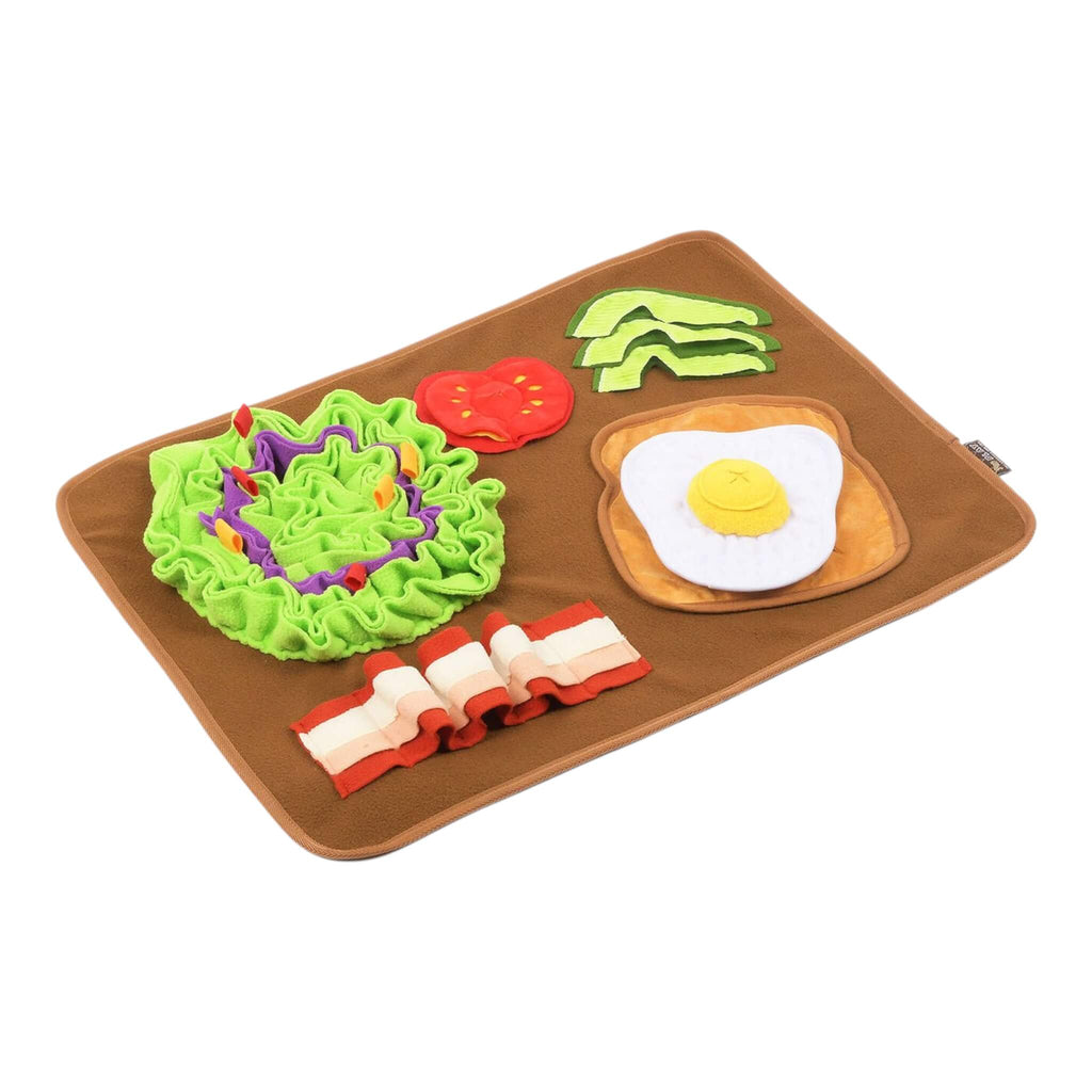 Dog snuffle mat with avocado, tomato, bacon, and egg on a brown tray