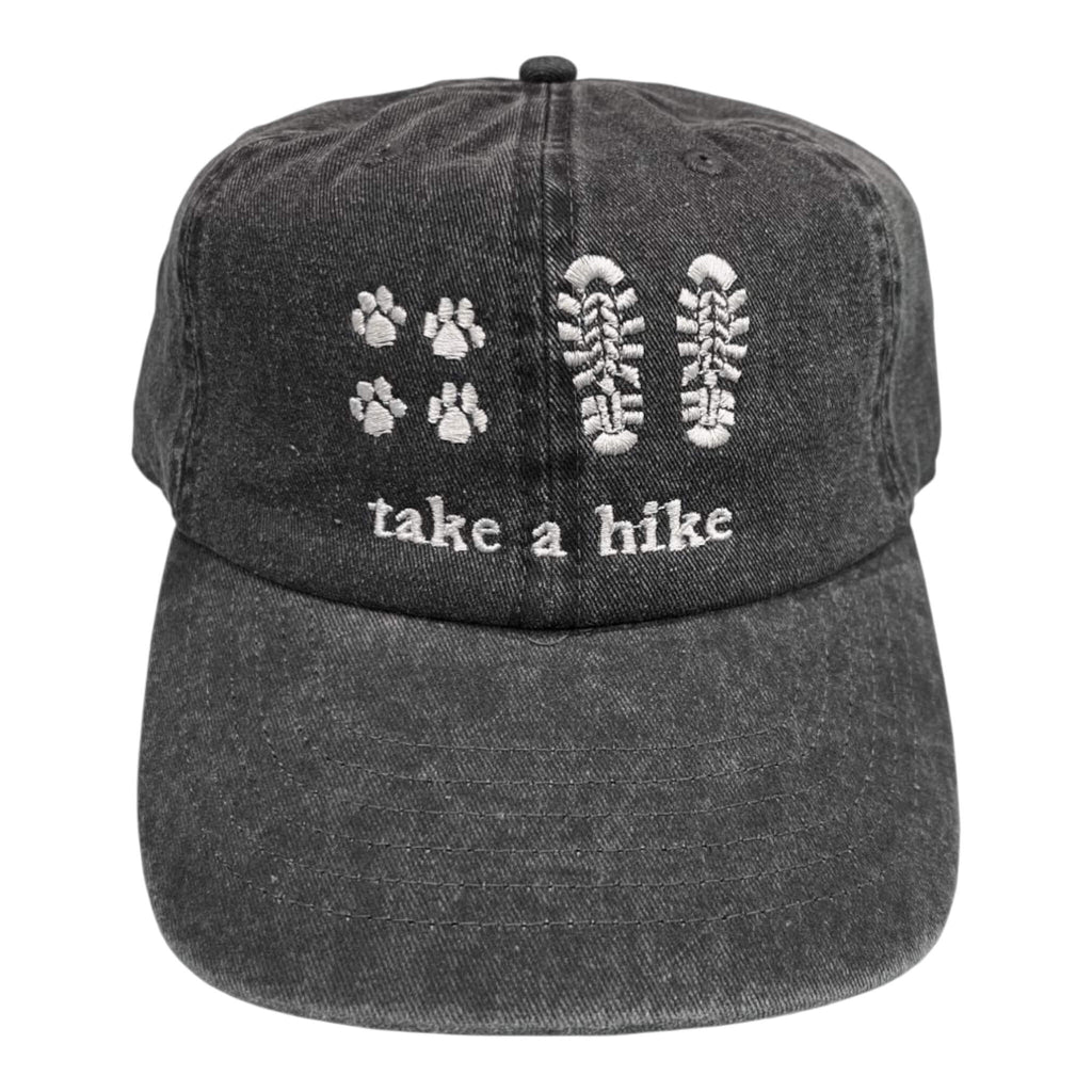 Grey cap with embroidered paw prints, boot prints, and 'take a hike' text on a white background