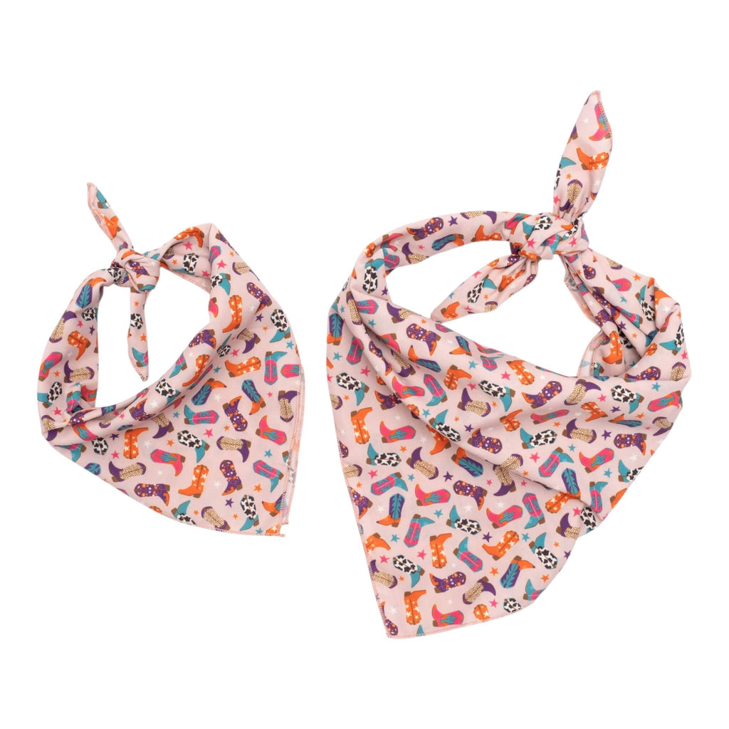 Two colorful dog bandanas with western-themed print pattern on a white background
