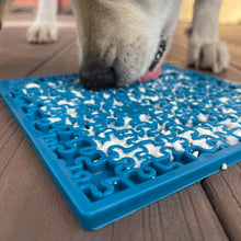 Load image into Gallery viewer, Dog licks up dinner from his blue enrichment licking mat
